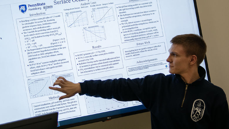 High school student Andrew Lees points to a screen showing his research project