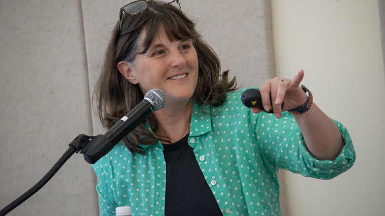 Kate Messner smiles and points to some to take a question during her presentation