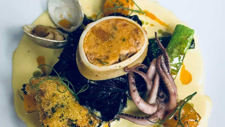 squid ink pasta with crispy Rhode Island oyster, poached squid sausage, sautéed curry clam, batonnet zucchini, and pan roasted butternut squash in a saffron cream sauce 