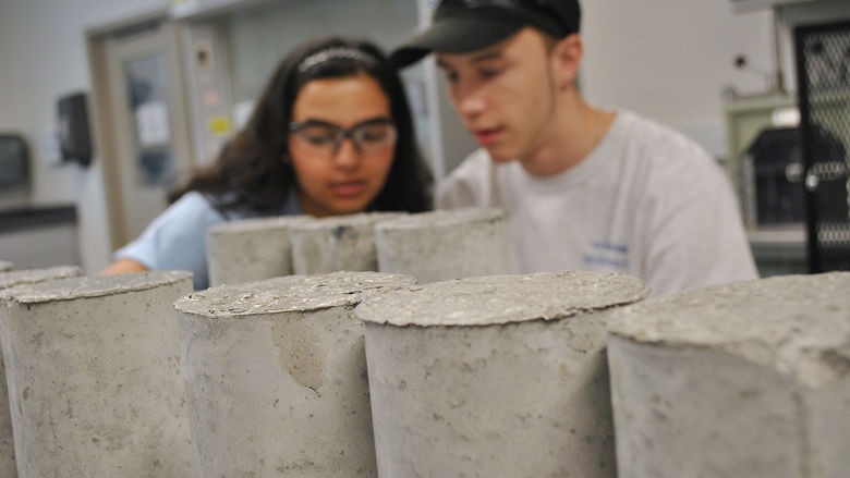 students testing concrete cylinders