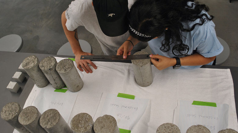 Students Kienan Dalesandro and Martina Soliman testing concrete samples