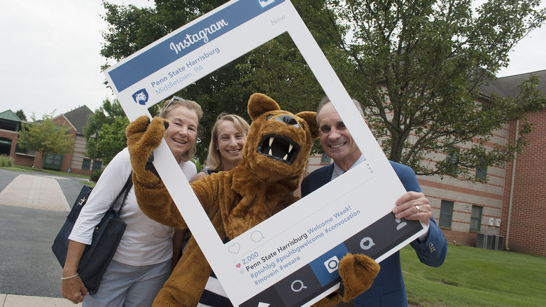 Chancellor John M. Mason Jr. poses for a group photo along with his wife, Michelle, daughter, Meghan, and the Nittany Lion during move-in at Penn State Harrisburg.