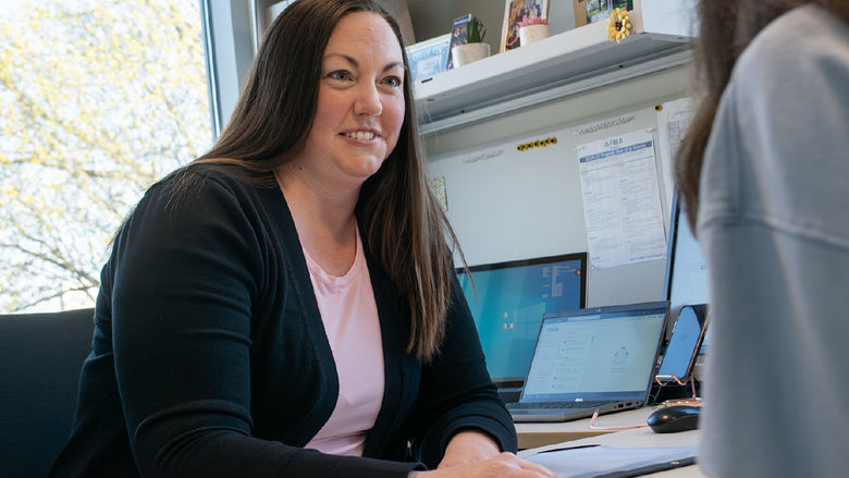 Jody Salsman works with a student in her office