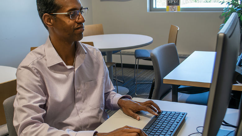 a professor working at a computer