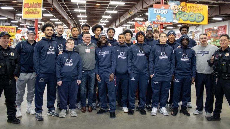 Group photo of Penn State Harrisburg basketball players with law enforcement officers