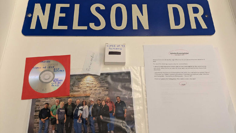Photo of a road sign that says Nelson Dr, a photo of Penn State Harrisburg alumni, and a dvd of photos