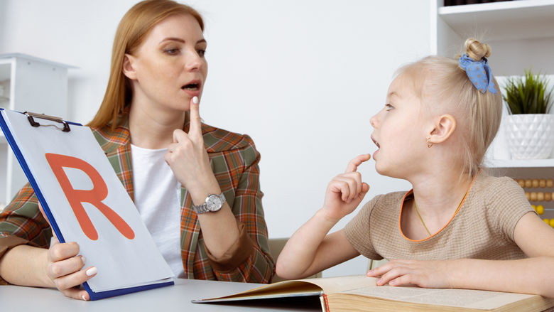 speech therapy concept. patient kid with female therapist training pronunciation