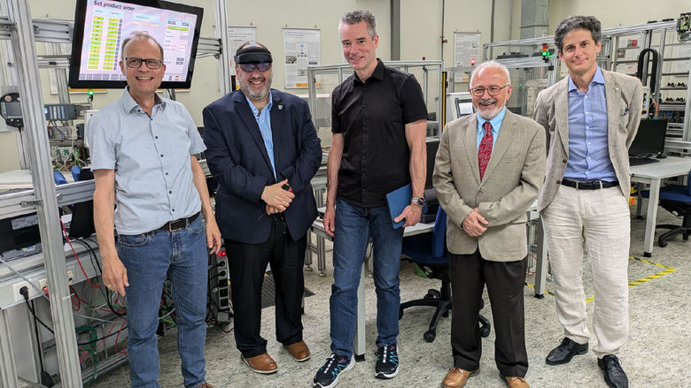 Five people standing in a lab