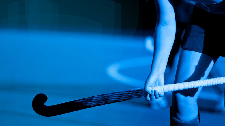 Blue-tinted graphic/photo of a field hockey player holding a field hockey stick