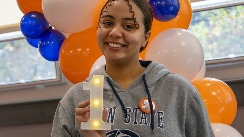 Student Raulybel Perez holds a 1 figure with lights