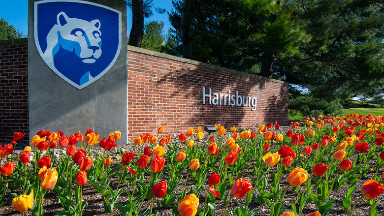 Penn State Harrisburg sign with tulips