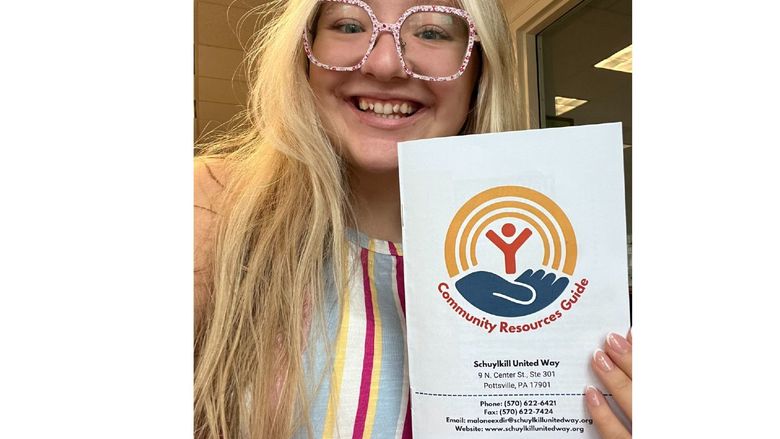 A student holds a brochure from the Schuylkill United Way