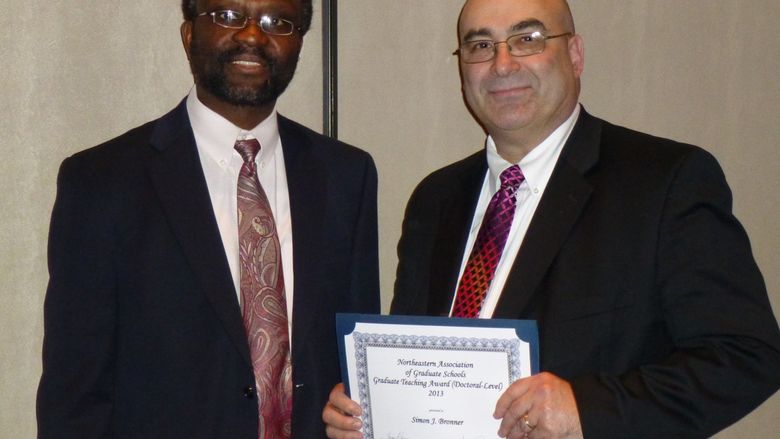 Dr. Simon Bronner (right) and Dr. Peter Idowu, assistant dean for graduate studies (left), at the NAGS award ceremony