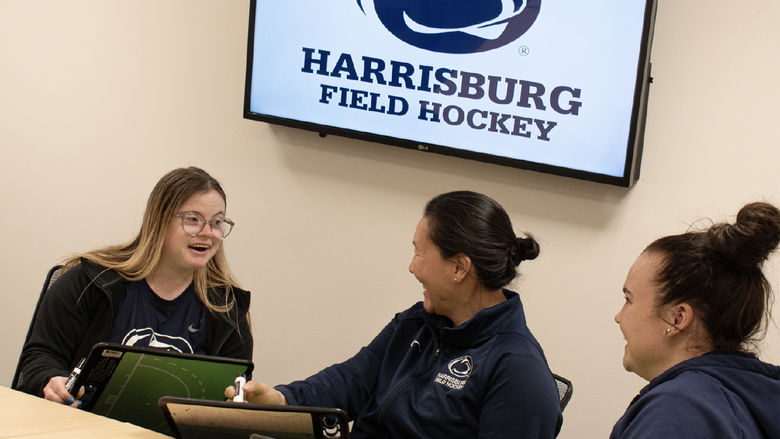 Photo of Maggie Kutz, field hockey coach Amanda Janney Misselhorn, and field hockey assistant coach Erica Metz