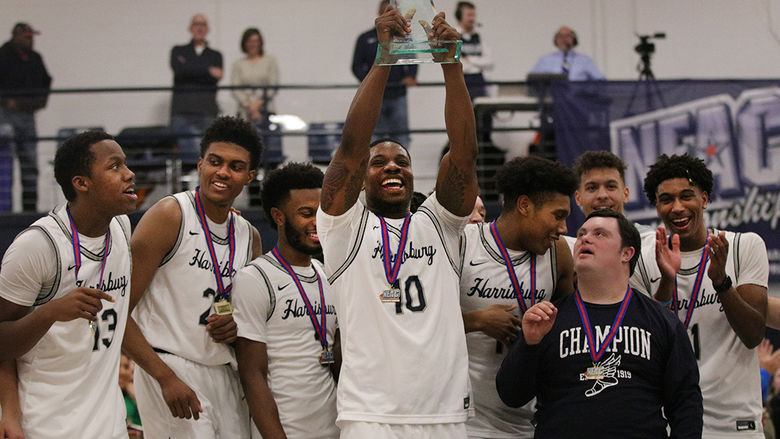 basketball players lifting trophy