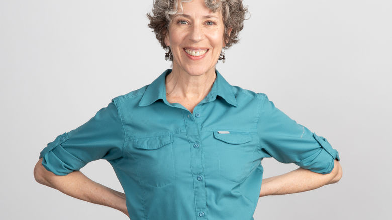 Michele Dunleavy wearing a robin egg blue shirt and smiling