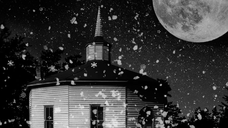 black and white image of a church on a snowy moonlit night