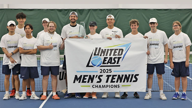 A group of men holding the United East 2025 Men's Tennis Champions banner