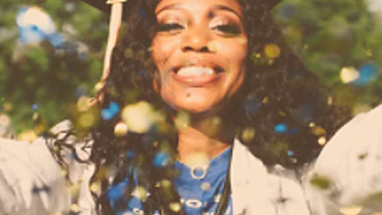 woman in graduation cap throwing confetti