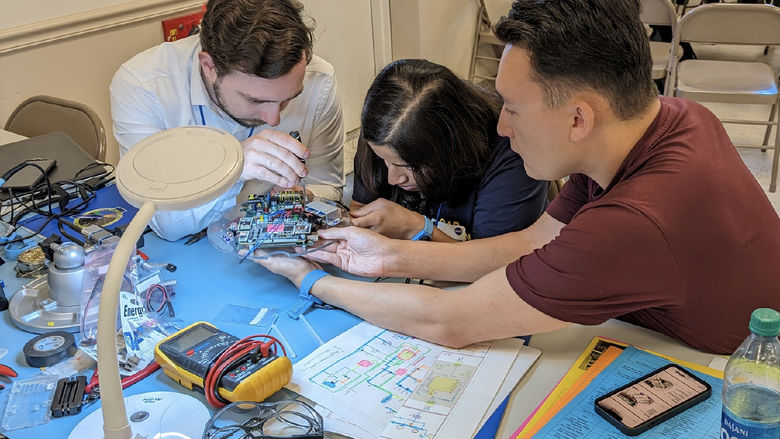 Three Penn State students work on a scientific payload for the NASA Rock On program