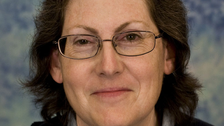 photo portrait of woman wearing glasses, collared shirt and dark sweater