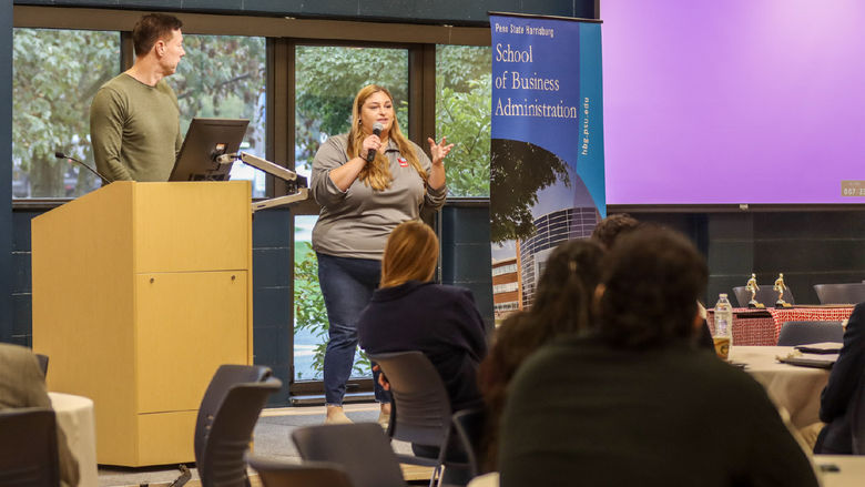 Company representative speak in front of a room