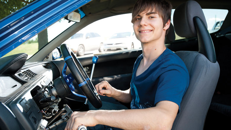 Steven Georges behind the wheel of his manual-transmission Honda, with a hand-operated clutch system he helped design.