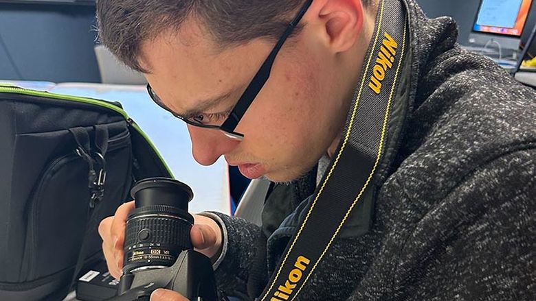 Tyler is learning how to use a professional camera in his academic class