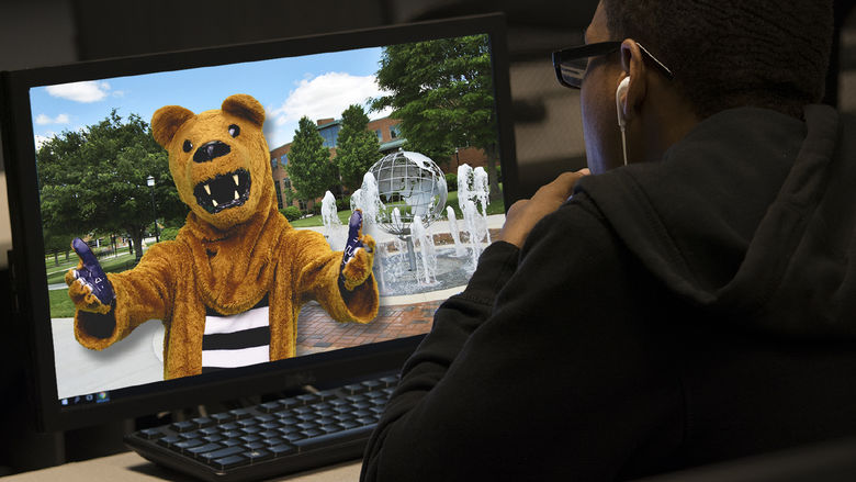 student looking at Nittany Lion on computer screen