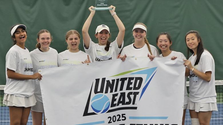 A group of women holding a banner that says United East 2025 women's tennis champions