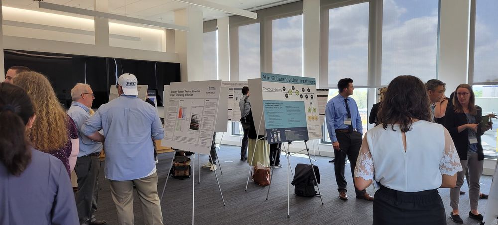 People standing in a room looking at conference posters