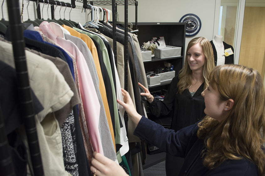 women looking at clothing racks