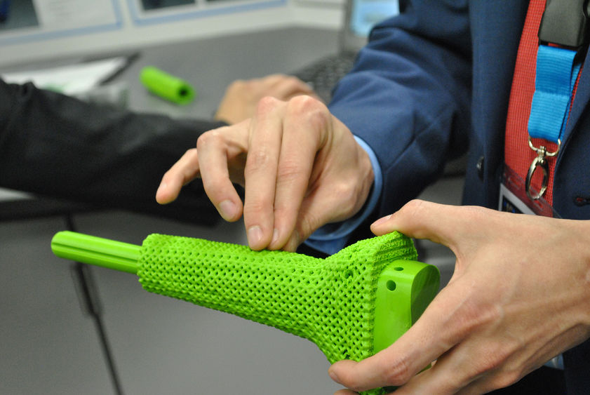student holding 3D printed prosthetic