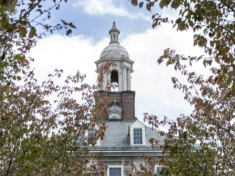 Old Main in the spring, framed by trees