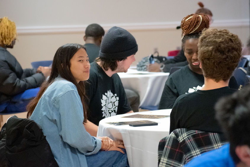 Students sit at tables during the anniversary celebration for the Multicultural Academic Excellence Program.