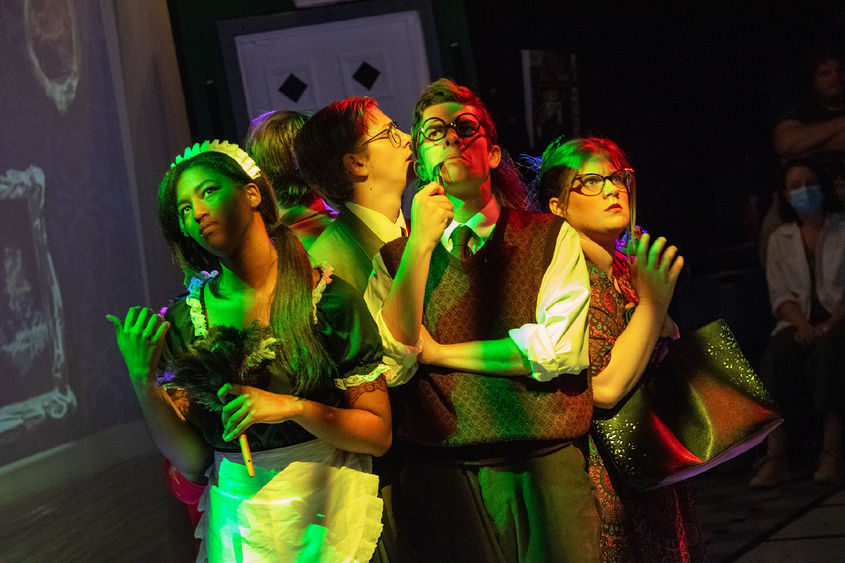 Characters huddle together in a scene from Penn State Harrisburg's fall play, "Clue."