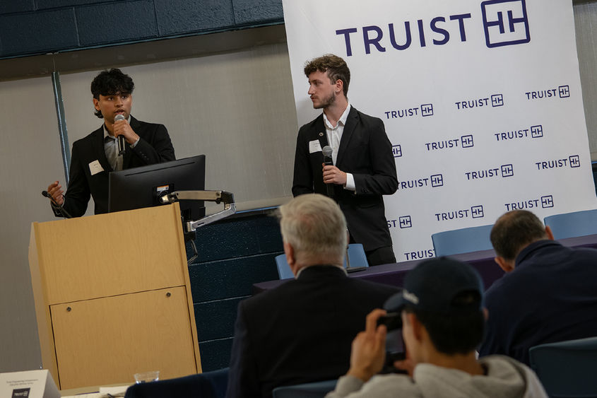 Penn State Harrisburg students Veer Patel and Tyler Muessig pitch their business idea, while standing at a lectern. 