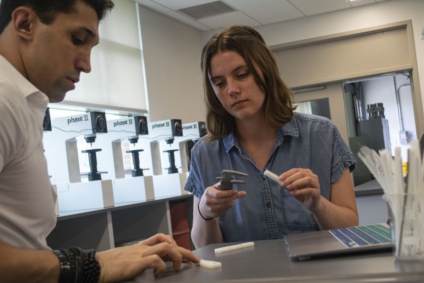 A man and a woman measuring samples in the lab