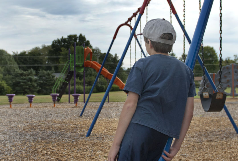 Child by swing set