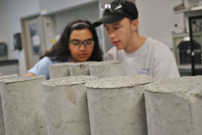 students testing concrete cylinders
