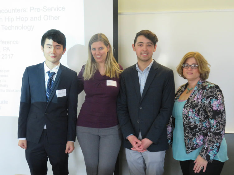 Students pose for camera after conference presentation.