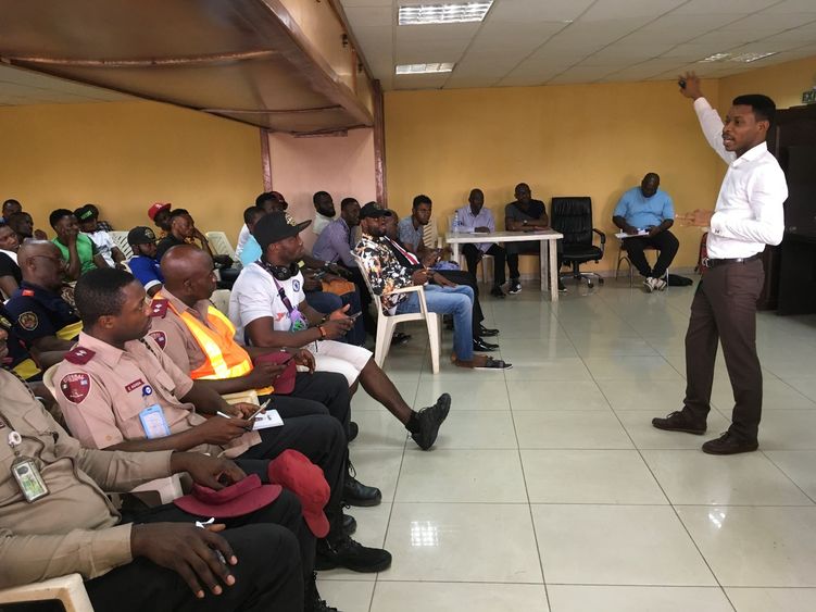 Abiodun Awoyemi stands in a conference room addressing a dozen people on safety before the Lagos Marathon.