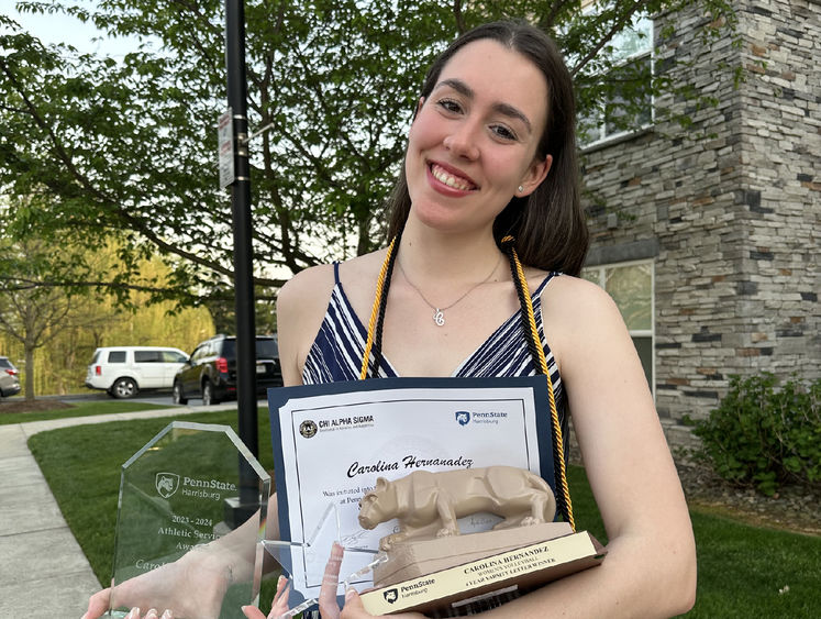 Carolina Hernandez holds certificates and awards