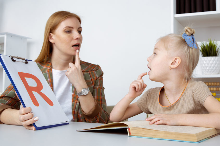 speech therapy concept. patient kid with female therapist training pronunciation