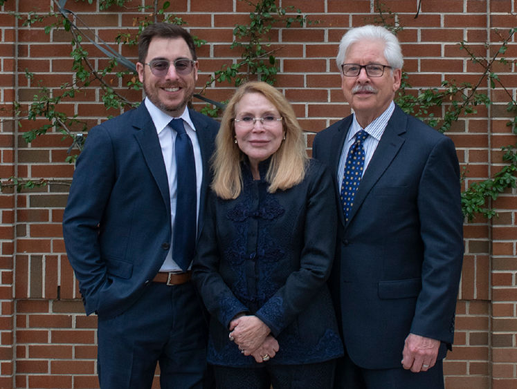 Dr. Madlyn Hanes poses with her husband and son