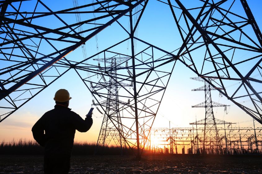 Electricity worker and pylon silhouette