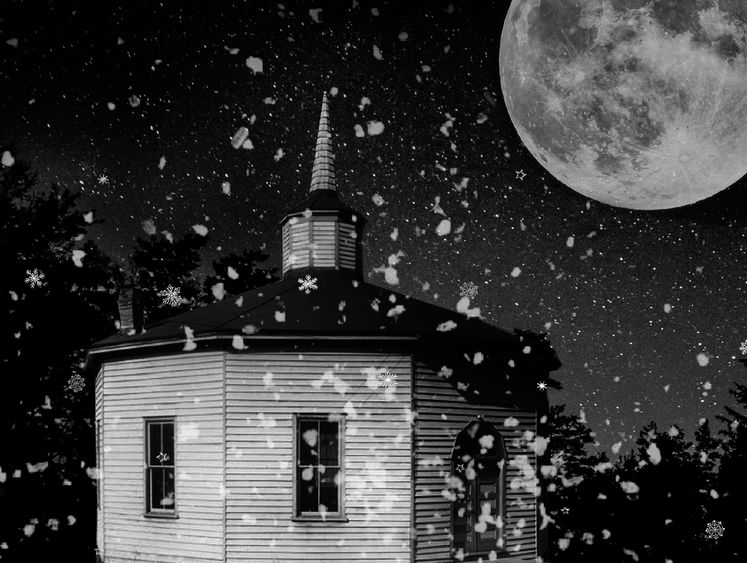 black and white image of a church on a snowy moonlit night