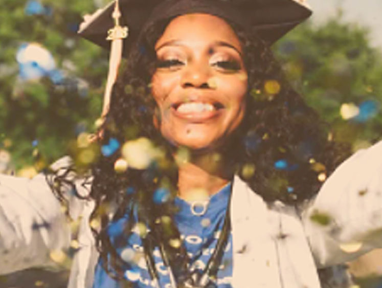 woman in graduation cap throwing confetti