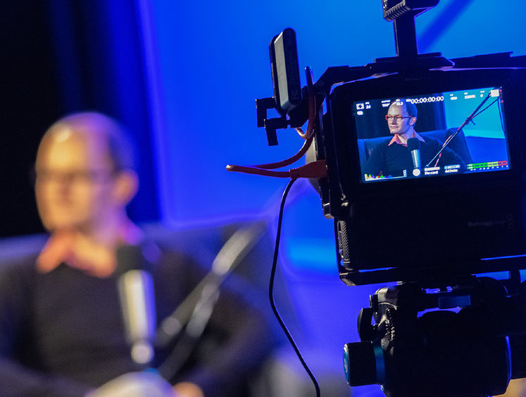 Faculty member Dan Mallinson viewed through a camera lens