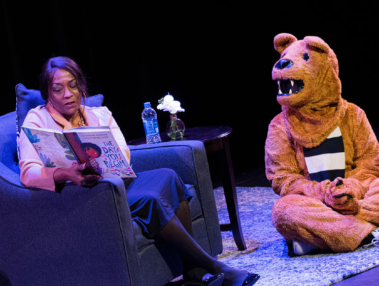 Wanda Knight, assistant dean for diversity, equity and inclusion at Penn State Harrisburg, reads a book to the Nittany Lion.